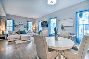 a living room with a table and a couch at Bright Norfolk Home with Deck Less Than 3 Mi to Town! in Norfolk