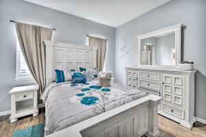 a white bedroom with a large bed and a mirror at Bright Norfolk Home with Deck Less Than 3 Mi to Town! in Norfolk