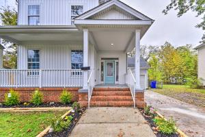 a white house with a blue door and stairs at Bright Norfolk Home with Deck Less Than 3 Mi to Town! in Norfolk