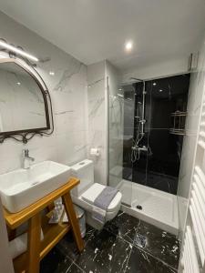 a bathroom with a toilet and a sink and a shower at VIRSA BOUTIQUE ROOMS in Ioannina