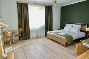 a bedroom with a large bed and a table and chairs at Sargsyan ECO house in Sevan