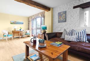 a living room with a couch and a table at The Neuadd Cottages in Crickhowell