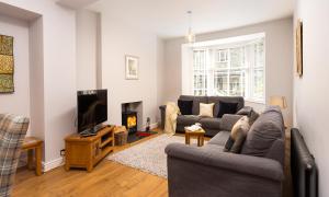 a living room with two couches and a tv at Hazel Cottage in Ambleside