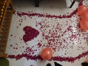 a bunch of red hearts on a wall with balloons at Ranthambhore Bagh Niwas in Sawāi Mādhopur