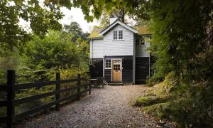 una casa blanca con una valla delante en Acorn Cottage, en Grasmere