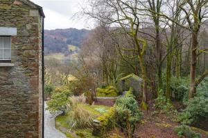 an entrance to a garden with a stone building at Silver Howe in Grasmere