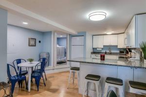 a kitchen with a counter and a table and chairs at 2BR Apt w/ 3 min Walk to downtown SWH - [Low Tide] in Southwest Harbor