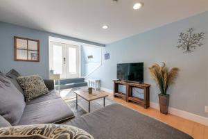 a living room with a couch and a flat screen tv at 2BR Apt w/ 3 min Walk to downtown SWH - [Low Tide] in Southwest Harbor