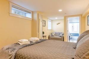 a bedroom with a bed with two towels on it at 2BR Apt w/ 3 min Walk to downtown SWH - [Low Tide] in Southwest Harbor