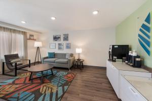 a living room with a couch and a tv in a room at WoodSpring Suites Dayton North in Dayton