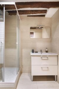 a bathroom with a shower and a sink at Edgar Suites Montorgueil - Caire in Paris