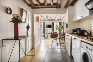 a kitchen with a vase of flowers on a counter at Edgar Suites Montorgueil - Caire in Paris