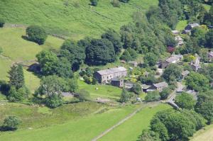 an aerial view of a house on a green hill at Thomas Cottage in Penrith