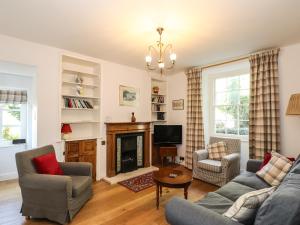 a living room with a couch and a fireplace at Jessicas Cottage in Bowness-on-Windermere
