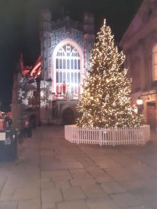 a christmas tree in front of a building with lights at Pulteney Road Apartment in Bath +55 photos