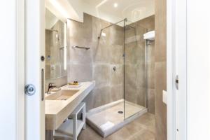a bathroom with a shower and a sink at Hotel Costa dei Fiori in Santa Margherita di Pula