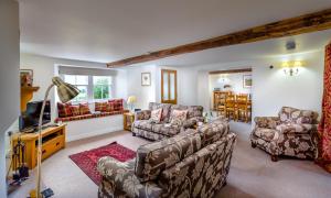 a living room with two couches and a tv at Low Longthwaite Farm in Watermillock