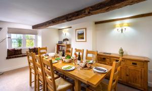 a dining room with a wooden table and chairs at Low Longthwaite Farm in Watermillock