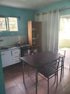a kitchen with a table and chairs in a room at Ruben Punta Negra in Punta Colorada