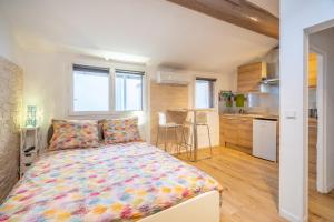 a bedroom with a bed with a colorful bedspread at 'Les Arsenaux' Studio de charme coeur de Marseille by Weekome in Marseille