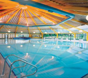 a large swimming pool with a large roof at Hotel67 in Killarney