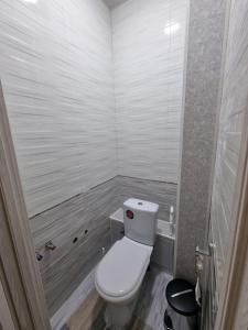 a bathroom with a white toilet in a room at APARTMENT “NOVZA” in Tashkent +18 photos