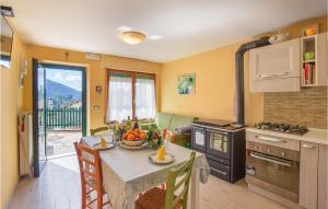 a kitchen with a table with a bowl of fruit on it at Gorgeous Home In Aune Di Sovramonte With House A Mountain View in Sovramonte