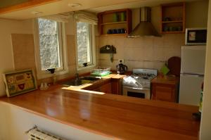 a kitchen with a wooden counter top and a refrigerator at Valle del Molino in Trevelin