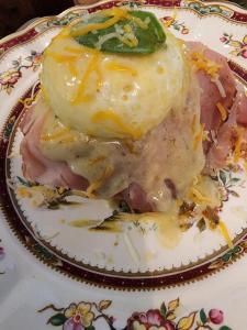 a plate of food with an egg on top at House of 1833 Bed and Breakfast in Mystic