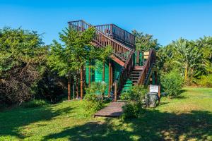 a house with a staircase leading up to it at Santorini - Perissa 41 in Ballito