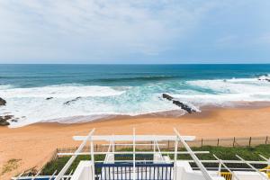a view of a beach with the ocean at Santorini - Perissa 41 in Ballito