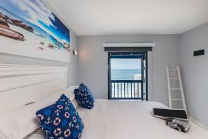 a bedroom with a bed with a view of the ocean at Santorini - Perissa 41 in Ballito