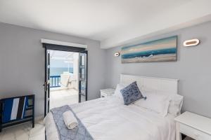 a bedroom with a bed and a view of the ocean at Santorini - Perissa 41 in Ballito