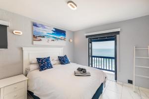 a bedroom with a bed with a view of the ocean at Santorini - Perissa 41 in Ballito