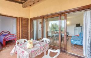 a dining room with a table and chairs and a living room at Trilo Sup in Trinità d'Agultu e Vignola +7 photos