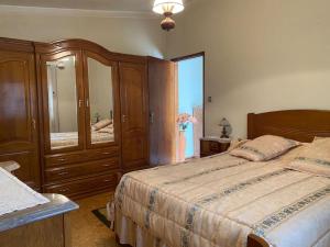 a bedroom with a bed and a dresser and a mirror at Casa de Vimioso AL in Vimioso