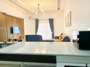 a kitchen and living room with a table and chairs at Luxury Comfortable One Bedroom In Lekki Phase1 in Lekki