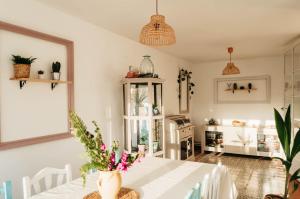 a dining room with a white table with flowers on it at ~Villa El Riu del Cel~Increíbles vistas al mar in Lloret de Mar