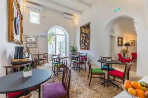 a restaurant with tables and chairs in a room at Mosta Dome B&B in Mosta