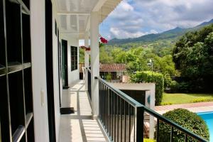 a balcony of a house with a swimming pool at Quinta Baroe in Guaduas