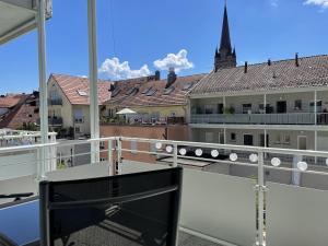 a balcony with a view of the roofs of buildings at Fewo Seehaase in Radolfzell am Bodensee