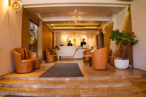 a lobby with orange chairs and a reception desk at Laguna Beach Hotel & Resort in Cox's Bazar