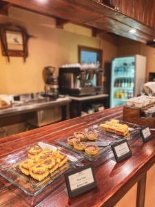 a counter with a bunch of pastries on it at Boutique Hotel La Cantera in El Calafate