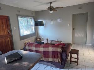 a living room with a couch and a table at Elegant 1-Bedroom Apartment with pool. in Richards Bay