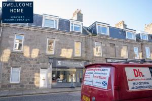 a red van parked in front of a building at Dwellcome Home Ltd 3 Double Bedroom Aberdeen Apartment - see our site for assurance in Aberdeen