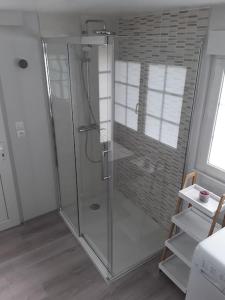 a shower with a glass door in a bathroom at Chez DOUDOU entre terre et mer in Bretteville-Saint-Laurent