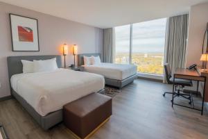 a hotel room with a large bed and a desk at Hollywood Casino at Greektown in Detroit