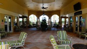 a lobby with green and white chairs and a plant at Windsor Hills Resort- 7682 Sir Kaufmann in Orlando