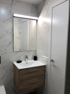 a bathroom with a sink and a mirror and a shower at Casa Alejandro 5 Las Vistas in Los Cristianos