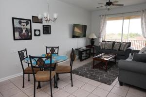 a living room with a table and a couch at Windsor Hills Resort- 402F in Orlando